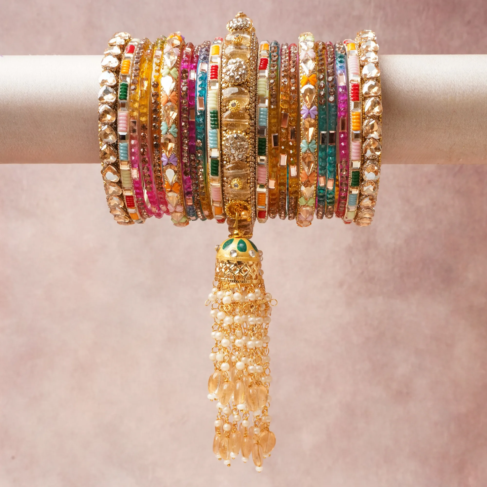 A commanding Multi colour anchors this beautiful set, enriched with accents of Clear Crystal, Fuchsia, Teal, Emerald Green, Ruby Red, Amber, Amethyst Purple, Light Pink, Orange, Pearl White that add depth and dimension.

Featuring a striking composition of Gold-toned Metal, Crystal, Glass Beads, Pearls, Meenakari Enamel, this set carries intricate craftsmanship and strong presence. Grand in form, it is created for moments that deserve to be marked.